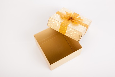 Golden christmas gift box with lid off on white background