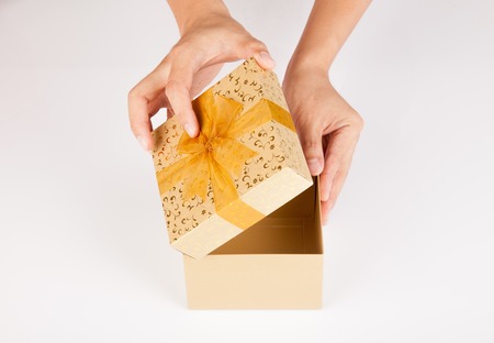 Man hands open golden gift box on white backgroundの写真素材
