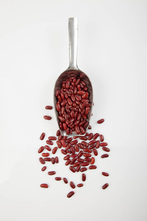 Red kidney beans with scoop on white backgroundの写真素材