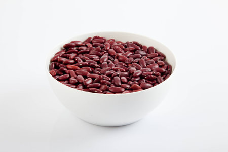 Red kidney beans in white bowl on white background