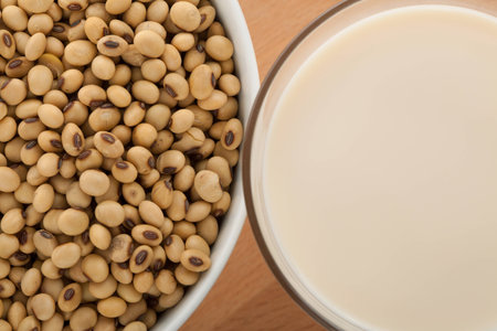 Close up of soy milk in glass with soybeans in bowlの写真素材