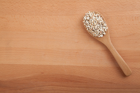 Jobs tears with wooden spoon on wood backgroundの写真素材