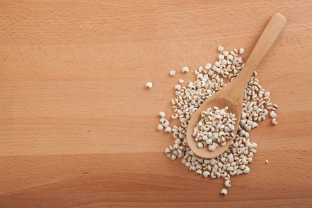 Jobs tears with wooden spoon on wood backgroundの写真素材
