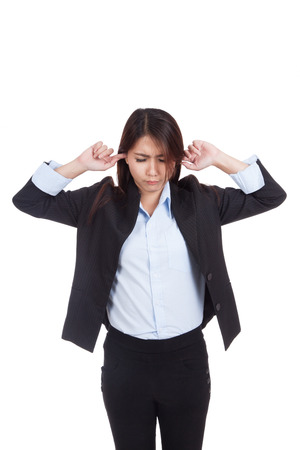 Young Asian businesswoman covering her ears  isolated on white backgroundの写真素材