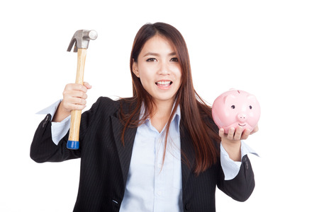 Young Asian businesswoman with hammer and  piggy bank  isolated on white backgroundの写真素材