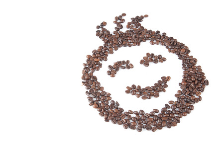 Roasted coffee beans in smile face shape  on white background