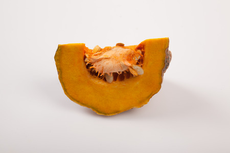 Cut  ripe orange pumpkin on white backgroundの写真素材