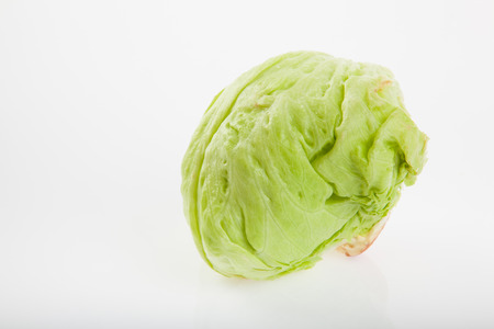 Fresh iceberg lettuce on white backgroundの写真素材