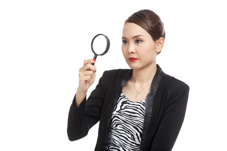 Young Asian business woman with a magnifying glass  isolated on white backgroundの写真素材