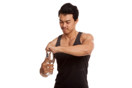 Muscular Asian man with bottle of water  isolated on white backgroundの写真素材