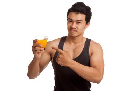 Muscular Asian man point to orange juiceの写真素材