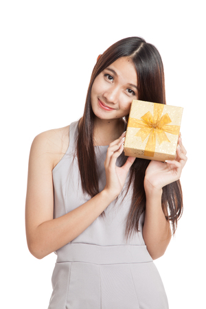 Beautiful young Asian woman with golden gift box  isolated on white backgroundの写真素材