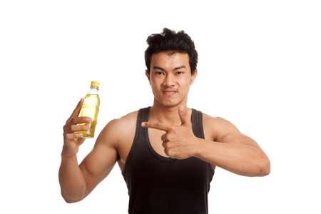 Muscular Asian man point to electrolyte drink  isolated on white backgroundの写真素材