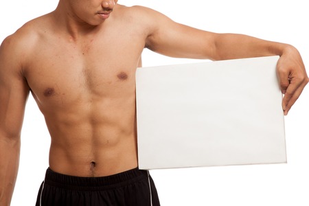 Muscular Asian man with blank sign  isolated on white backgroundの写真素材