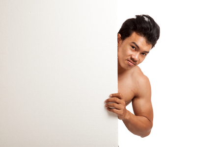 Muscular Asian man behind  blank sign  isolated on white backgroundの写真素材