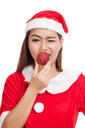 Asian Christmas girl with Santa Claus clothes with bauble ball  isolated on white backgroundの写真素材