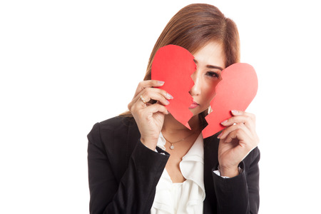 Beautiful young Asian woman with broken heart  isolated on white backgroundの写真素材