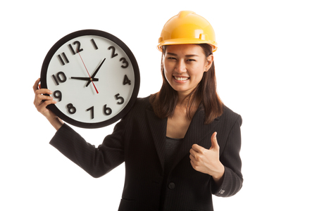 Asian engineer woman thumbs up with a clock  isolated on white background.の写真素材