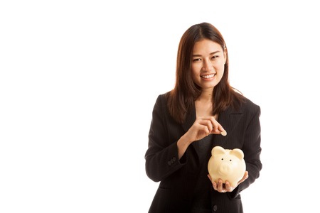 Asian business woman with coin and pig coin bank  isolated on white background.の写真素材