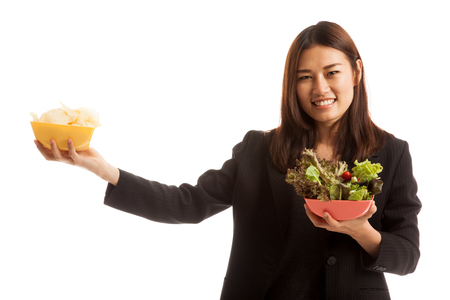 Young Asian business woman with potato chips and salad  isolated on white background.の写真素材