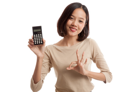 Asian business woman show OK with calculator  isolated on white background .の写真素材
