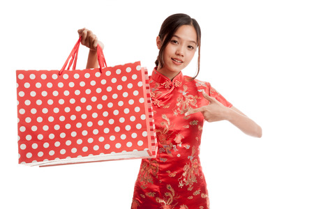 Asian girl in chinese cheongsam dress with shopping bag   isolated on white background .の写真素材