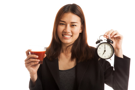 Young Asian business woman with tomato juice and clock  isolated on white background.