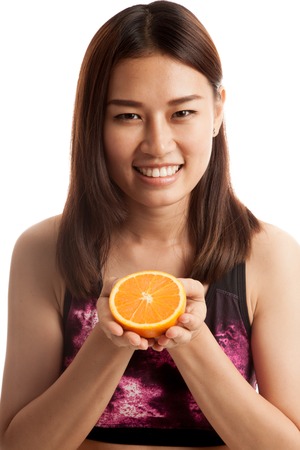 Beautiful Asian healthy girl with orange fruit  isolated on white background.の写真素材