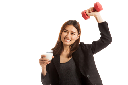 Healthy Asian woman drinking a glass of milk and dumbbell  isolated on white background.の写真素材