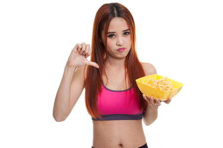 Asian healthy girl thumbs down with  french fries  isolated on white background.の写真素材
