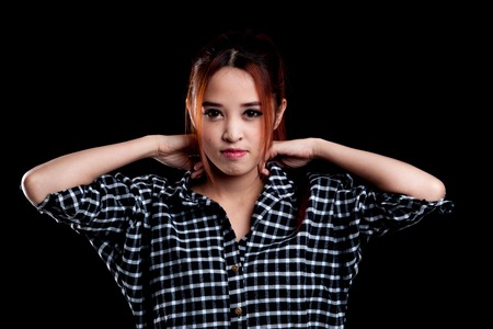 Portrait of beautiful young Asian woman on dark black backgroundの写真素材