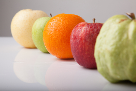 Five fruit , guava orange, redapple, green apple  chinese pear, on white backgroundの写真素材