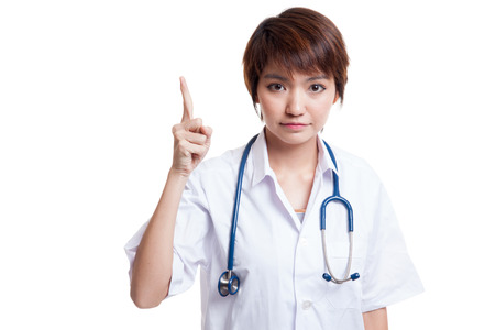 Asian young female doctor point up  isolated on white background.の写真素材