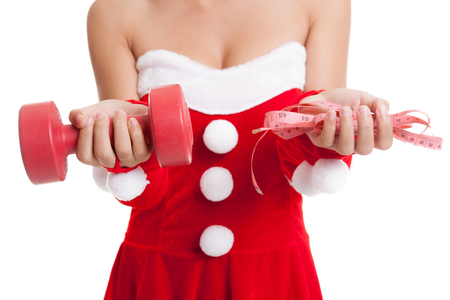 Asian Christmas Santa Claus girl with measuring tape and dumbbell  isolated on white background.の写真素材