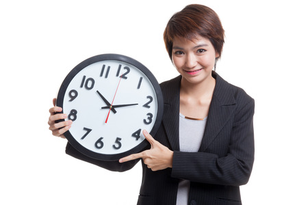 Young Asian business woman with a clock  isolated on white background.の写真素材