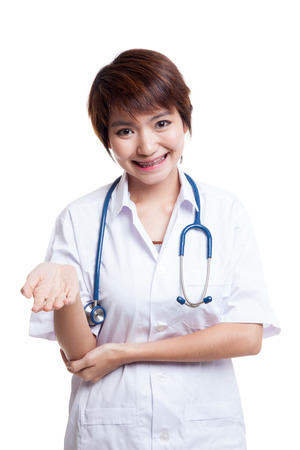 Asian young female doctor smile show her hand  isolated on white background.の写真素材