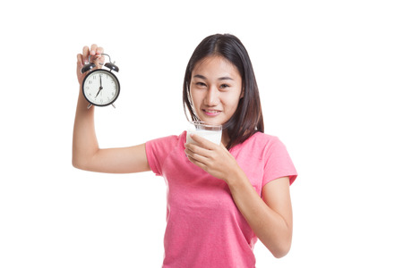 Healthy Asian woman drinking  glass of milk hold clock  isolated on white background.
