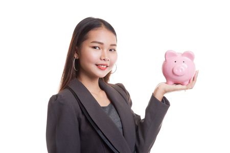 Young Asian business woman with a pig coin bank  isolated on white background.の写真素材