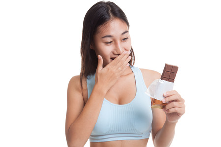 Beautiful  healthy Asian girl very happy with chocolate  isolated on white background.の写真素材