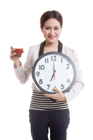Young Asian business woman with tomato juice and clock  isolated on white background.の写真素材