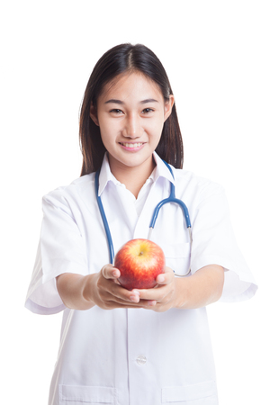 Young Asian female doctor show an apple  isolated on white background.の写真素材