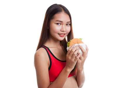 Beautiful Asian healthy girl enjoy eating  hamburger  isolated on white background.の写真素材