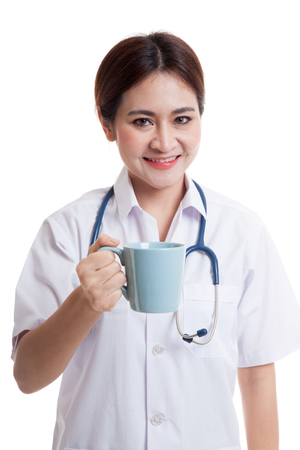 Young Asian female doctor hold a mug and smile  isolated on white background.の写真素材