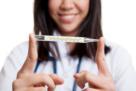 Young Asian female doctor with thermometer focus on thermometer   isolated on white background.の写真素材
