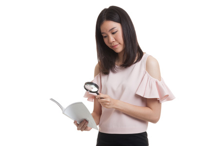 Asian business woman with a book and magnifying glass  isolated on white background.の写真素材