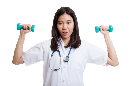 Young Asian female doctor  with dumbbell in both hands isolated on white background.の写真素材