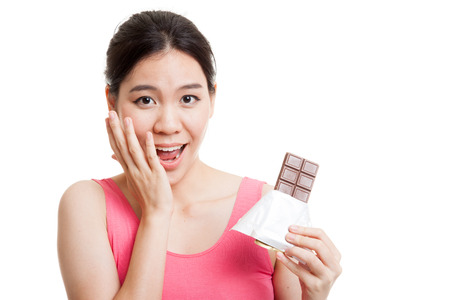 Beautiful  healthy Asian girl very happy with chocolate  isolated on white background.の写真素材