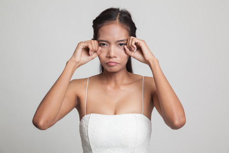Young Asian woman sad and cry  on gray backgroundの写真素材