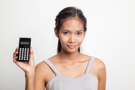 Asian woman smile with calculator on white backgroundの写真素材