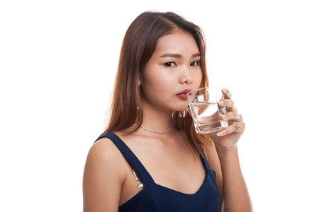 Young Asian woman with a glass of drinking water isolated on white backgroundの写真素材